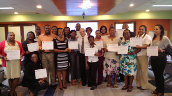 Bragging Rights! Participants proudly display their certificates in the company of training facilitator, David Logan