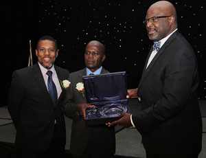 Mr. Ronald Jackson, Executive Director, CDEMA (left) joins the Hon. Adriel Brathwaite, Attorney General and Minister of Home Affairs, Barbados and Chairman of the CDEMA Council of Ministers (right) in presenting the award to Mr. Collymore (Bahamas Information Service Photo/Raymond A. Bethel, Sr.)
