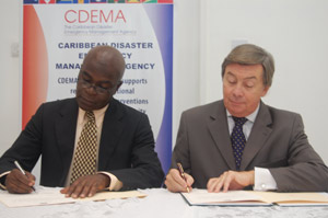 Mr. Jeremy Collymore, Executive Director, CDEMA and Ambassador Acquarone sign the agreement