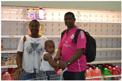 Maritza Crogman, beneficiary of the Voucher Programme shopping with her family